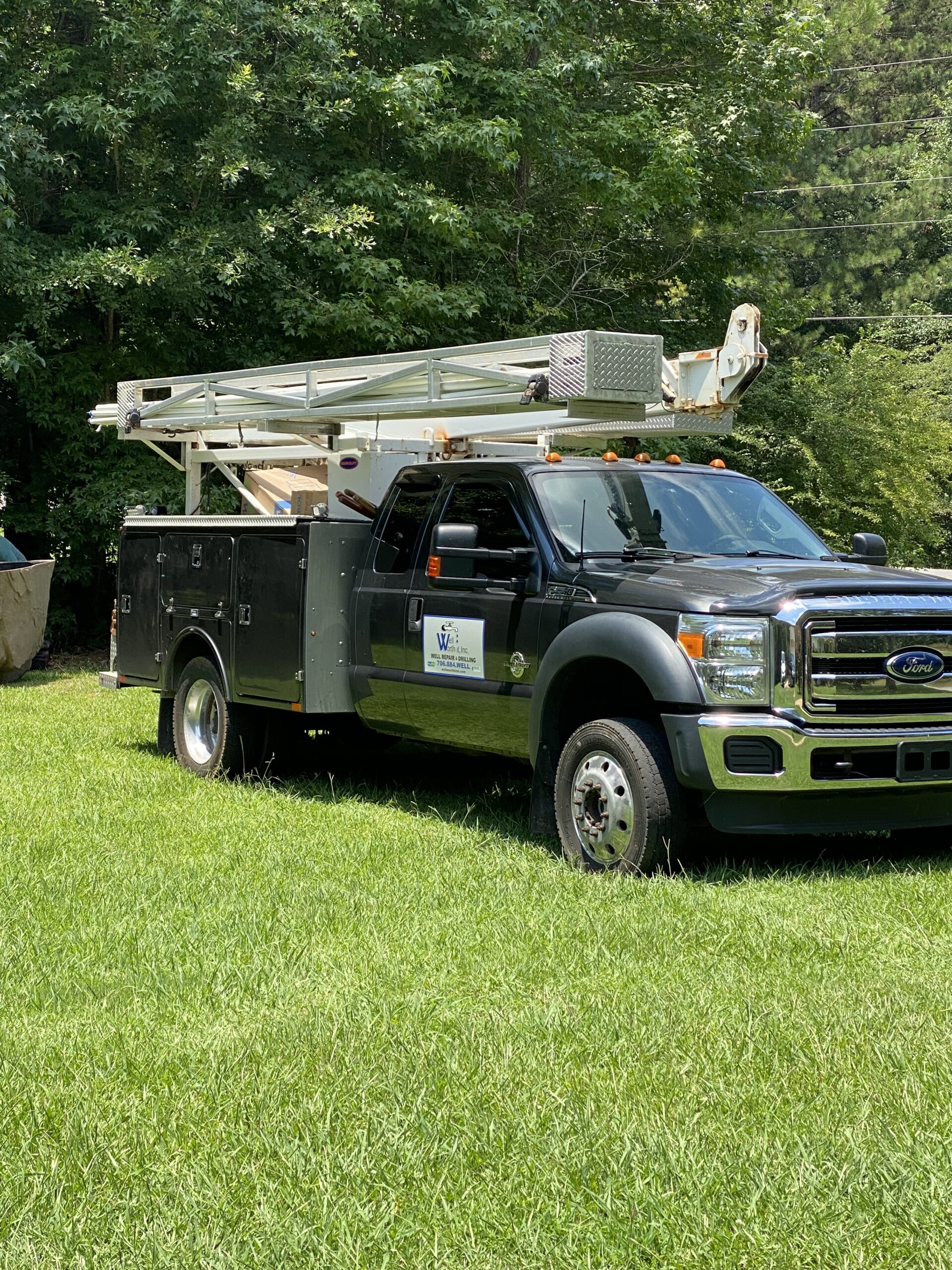 Well Worth It.Inc. black color repair truck parked